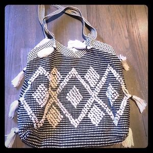 Black and white pattern tote with tassels